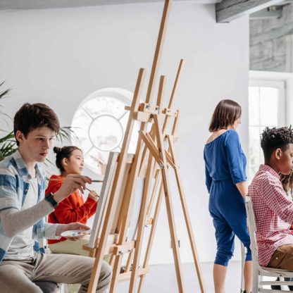 children painting on canvass