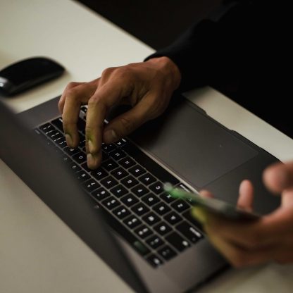 hand with laptop and phone