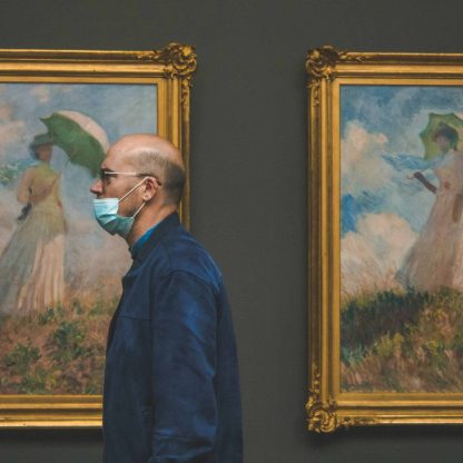 men standing in front of paintings