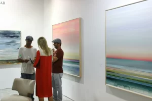 three-people-front-of-art-paintings